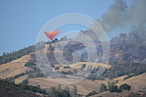 Aerial Firefighting Aircraft Releasing Fire photo