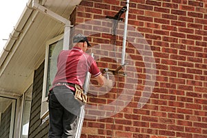 Aerial fitter on ladder photo