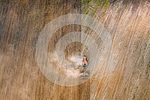Aerial Flat View. Tractor Plowing Field In Spring Season. Beginning Of Agricultural Spring Season. Cultivator Pulled By