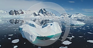 Aerial flight above giant iceberg melting hole