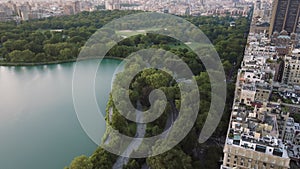 Aerial flight above green forest of Central Park on Manhattan, New York City 4K