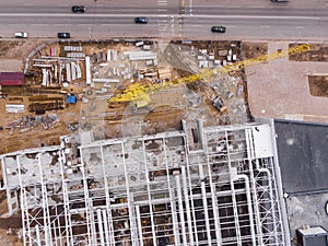 Aerial flight over construction site and construction crane. Aerial photography