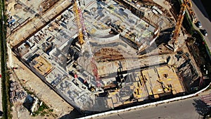 Aerial Flight Over a New Constructions Development Site with High Tower Cranes Building Real Estate. Heavy Machinery and