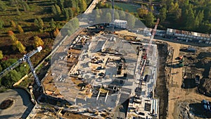 Aerial Flight Over a New Constructions Development Site. Urban Construction Site, Aerial View. High crane works on building site.