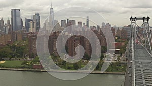 AERIAL: Flight over Williamsburg Bridge Manhattan side with New York City Skyline at cloudy day