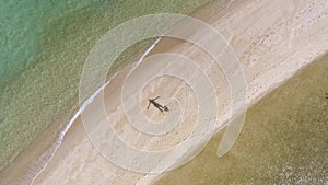 Aerial Fly Away: Young Mixed Race Girl in Bikini Spinning on the Beach. Koh Phangan, Thailand.