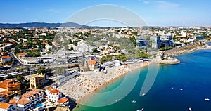 Aerial Fly Over People Crowd Having Fun On Beach And Cascais City In Portugal