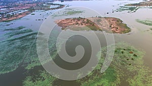 Aerial fly over top view of big lake or pond to abadon island, moving camera view shot, High quality footage 4K