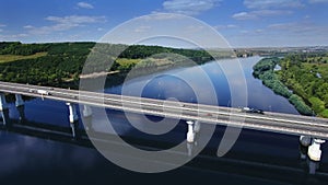 AERIAL Fly over traffic bridge highway roadway road way and blue river with trees forest, Europe, Russia, Tatarstan