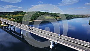 AERIAL Fly over traffic bridge highway roadway road way and blue river with trees forest, Europe, Russia, Tatarstan