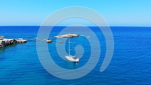 Aerial fly over white yacht and blue sea, Crete, Greece
