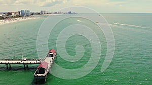 Aerial fly Pinellas County, Florida, United States. Pier and wharf without ships. View of the city from the sea.