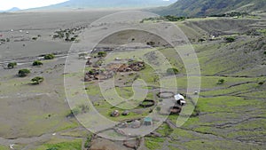 Aerial Flyby View on the Maasai village in front of the Ol Doinyo Lengai, Mountain of God in the Maasai language, Engare