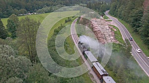 AERIAL: Flying above a vintage steam engine travelling along a rural road.