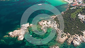 Aerial flying on Costa Smeralda, blue water waves in the Mediterranean Sea on white beach in Sardinia.