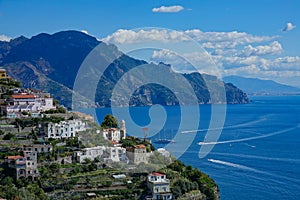 AERIAL: Flying towards beautiful coastal village on a hill in the Mediterranean.