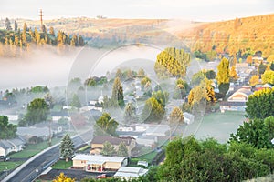 Aerial foggy landscape of small town USA in countryside Colfax, Eastern Washington