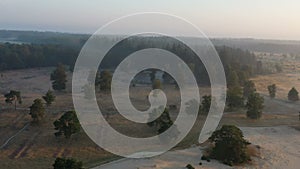 Aerial from a foggy nature landscape at nature reserve Kale Duinen in Appelscha the Netherlands