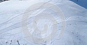 Aerial follow over skier alpine skiing in winter snowy mountain ski track field in sunny day.Above Alps mountains snow