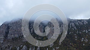 Aerial footage above a foggy mountain during fall season