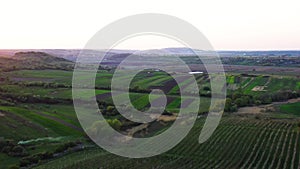 Aerial footage of an agricultural area and green rolling fields.