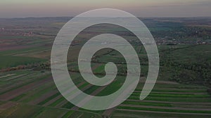 Aerial footage of an agricultural area and green rolling fields.