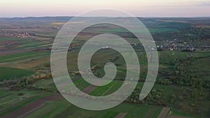 Aerial footage of an agricultural area and green rolling fields.