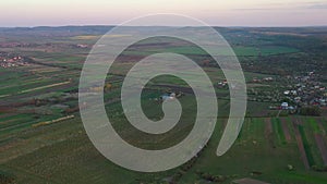 Aerial footage of an agricultural area and green rolling fields.
