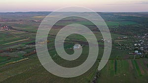 Aerial footage of an agricultural area and green rolling fields.