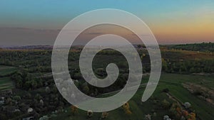 Aerial footage of an agricultural area and green rolling fields.