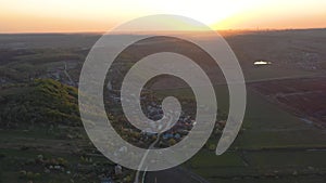 Aerial footage of an agricultural area and green rolling fields.