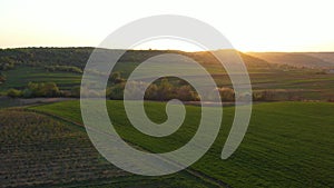 Aerial footage of an agricultural area and green rolling fields.