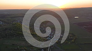 Aerial footage of an agricultural area and green rolling fields.