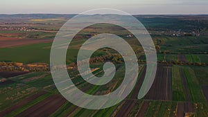 Aerial footage of an agricultural area and green rolling fields.