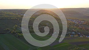 Aerial footage of an agricultural area and green rolling fields.