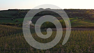 Aerial footage of an agricultural area and green rolling fields.