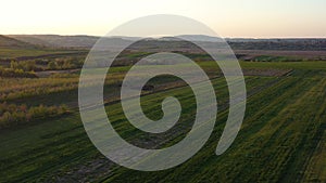 Aerial footage of an agricultural area and green rolling fields.