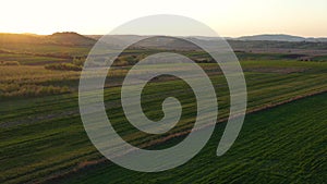 Aerial footage of an agricultural area and green rolling fields.