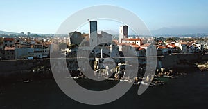 Aerial footage of Antibes, France, Cote D Azur. Beautiful sunny day in Mediterranean Sea. Old castle and sea. Roofs and