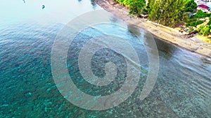 Aerial footage of a beach with swashing sea water