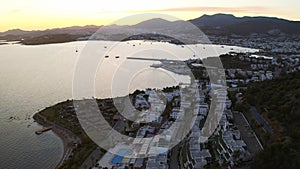 Aerial footage of Bodrum Halicarnassus bay with white houses at the sunset