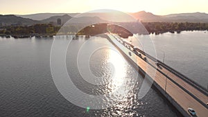 Aerial footage of bridge leading to Downtown Kelowna on Lake Okanagan at sunrise with beautiful light. 4K 24FPS.