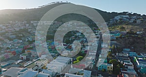 Aerial footage of brightly coloured houses on slope of Signal Hill in Bo Kaap residential borough. Cape Town, South