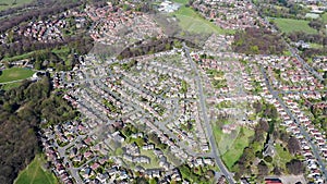 Aerial footage of the British town of Meanwood in Leeds West Yorkshire showing typical UK housing estates and rows of houses from