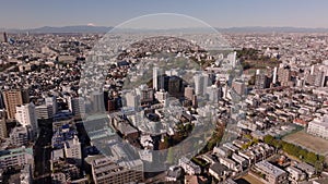 Aerial footage of buildings in residential urban borough in metropolis. Komaba Campus of university. Tokyo, Japan