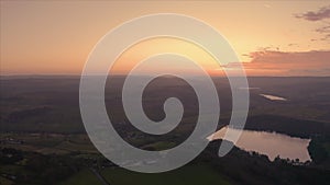 Aerial footage of a calm still lake Agden Reservoir at sunset over Bradfield