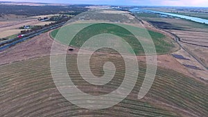 Aerial footage of circle crop irrigation along River Murray on hay crop