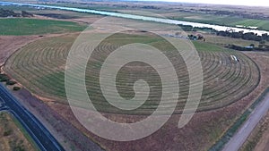 Aerial footage of circle crop irrigation along River Murray on hay crop