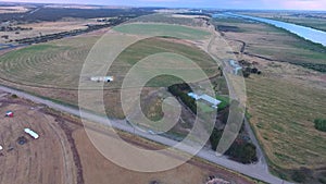 Aerial footage of circle crop irrigation along River Murray on hay crop