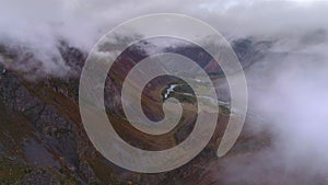 Aerial footage of a cloudy mountain valley. flight over